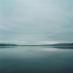 Fototapeta premium view of a lake, overcast sky, sparse clouds, symmetrical, photography