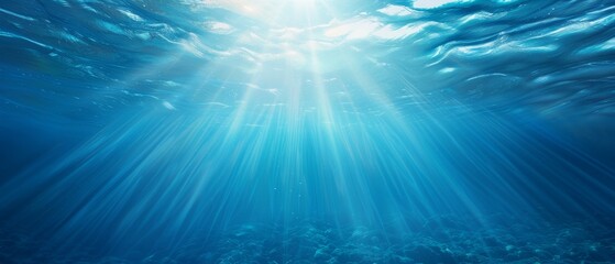 Obraz premium A blue ocean beneath, light filtering in from above waters and below surface