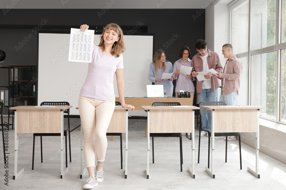 Sticker happy female student with results of exam in classroom