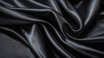 Sleek black silk fabric draped gracefully, creating an elegant and luxurious appearance in the image.