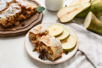 Plate with piece of tasty pear strudel and fresh fruit slices, closeup