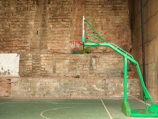 This is an indoor basketball hoop in a residential area in Chongqing, and the court is located under a bridge hole. © sunlinght