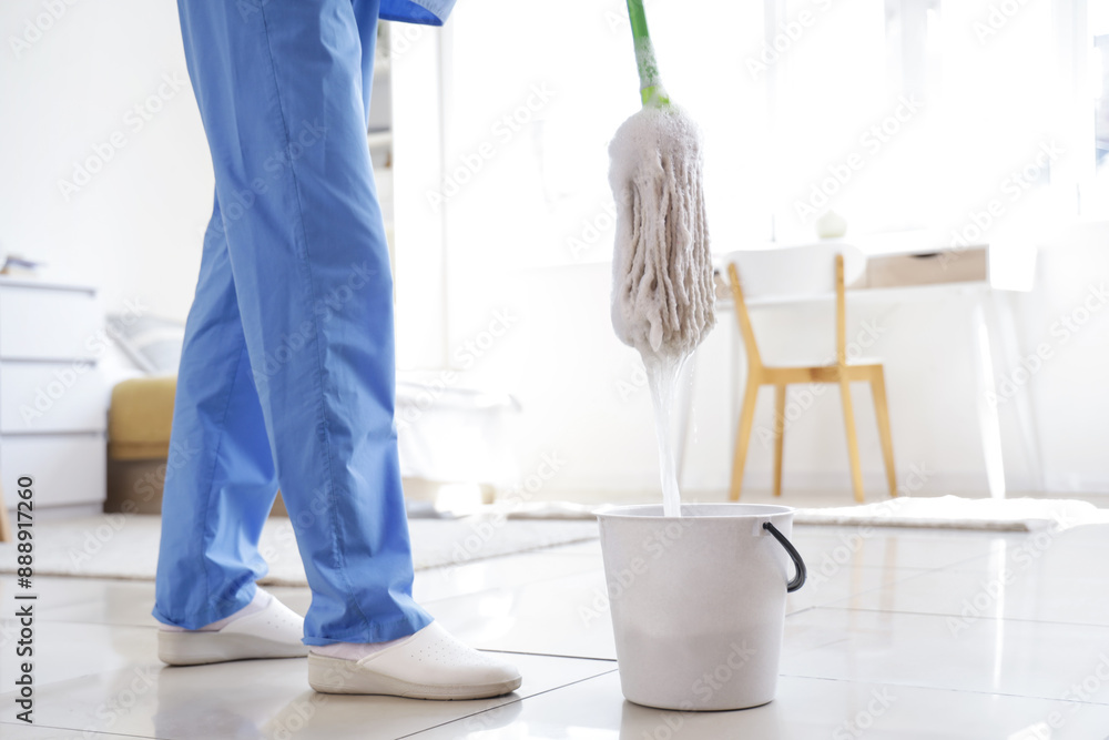 Poster janitor dipping mop into bucket in dorm room