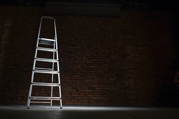 Step ladder on the construction site background. Front view with copy space.