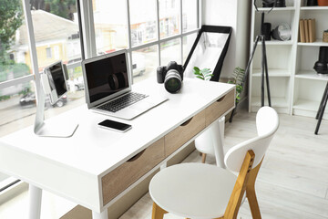 Modern gadgets on photographer's desk in office