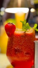 Glass of fresh strawberry drink with basil leaf on grey table, Space for text Vitamin beverage for recipe