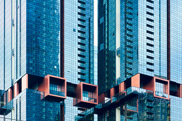 Naklejka premium Modern architecture facade reflecting blue sky in kuala lumpur malaysia