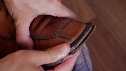 Repairing old men's shoes using glue close-up