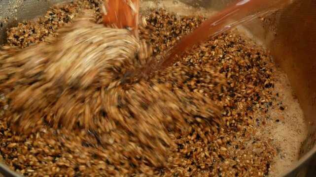 Mashing malt and maintaining temperature pauses during the preparation of homemade beer close-up