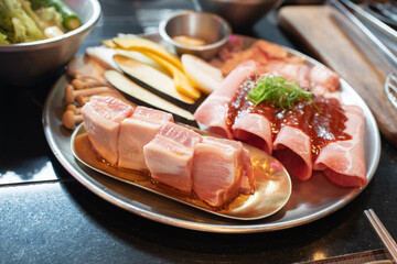 Tray with fresh pork raw and vegetables,ingredients for marinated , ready for cooking in Korean barbecue restaurant.