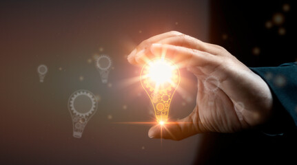 Creativity and new ideas Concept. Man holding light bulb in hand.