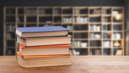 stack of books in library on wooden table