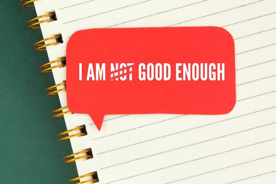 books and conversation boxes with the words I AM NOT GOOD ENOUGH.
