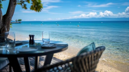 Obraz premium A beach scene with tables and chairs set up for a meal. The tables are covered with plates, glasses, and utensils. The chairs are arranged around the tables, and there are potted plants