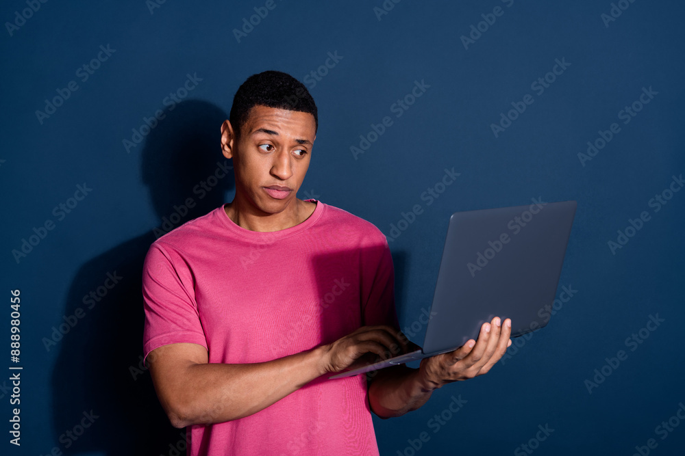 Canvas Prints Portrait photo of young successful it specialist with modern light laptop coding thoughtful focused isolated on dark blue color background