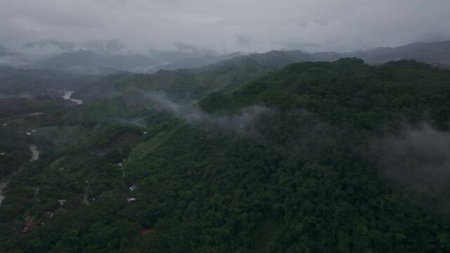 Aerial view of misty river winding through lush forest in Semuc Champey, Alta Verapaz, Guatemala.
