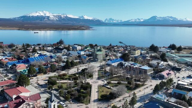 Patagonia City At Puerto Natales Antarctica Chile. Aerial View Of A Bustling City With High-Rise Buildings And Traffic. Snowing Lake Glacial Landscape Frozen. Forest Trees Glacial Landscape Nature.