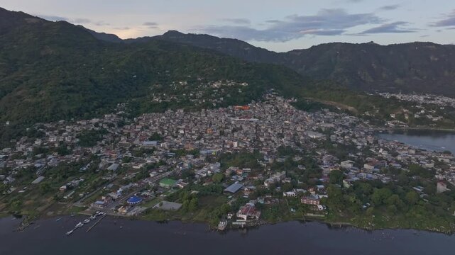 Aerial view of town, lake, and mountain at sunrise with city and volcano, San Pedro La Laguna, Solola, Guatemala.