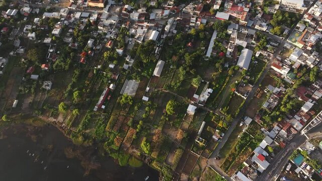 Aerial view of sunrise over lake and city with volcano, San Pedro La Laguna, Solola, Guatemala.