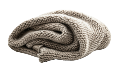 A soft, beige knit blanket rolled up on a white background