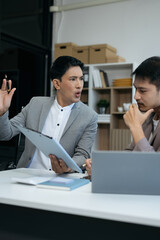 Angry boss blames sad male employee for incompetence computer error in office.