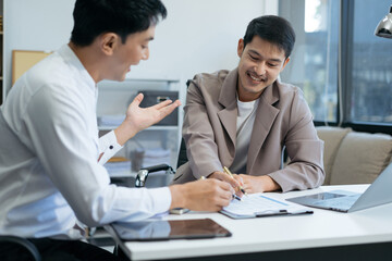 Business team working on a project in the office or reviewing and discussing a business project.