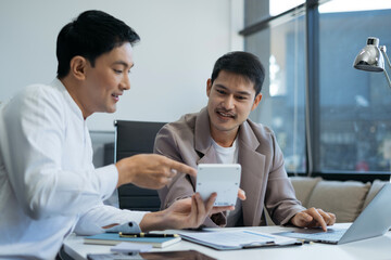Business team working on a project in the office or reviewing and discussing a business project.