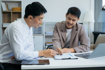 Business team working on a project in the office or reviewing and discussing a business project.