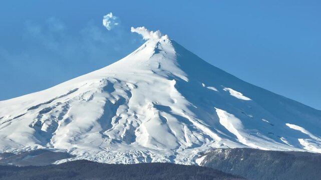 Villarrica Volcano At Pucon Los Lagos Chile. Snow-Capped Volcano Releasing Plumes Of Smoke Into Blue Sky. Snowy Lake Iceland Exploring. Snowy Nature. Pucon Los Lagos.