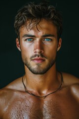 Muscular man with intense gaze and tousled hair.