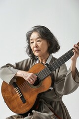 Obraz premium Korean woman playing an imaginary guitar looking p 078 guitar, music, woman, musician, playing, guitarist, instrument, acoustic, play, rock, boy, person, musical, teenager, child, hair, song, smiling