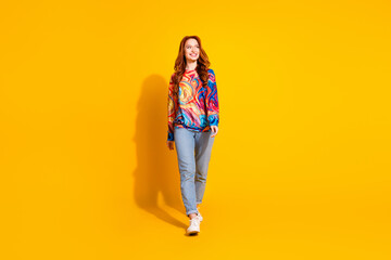 Photo of lovely adorable girl wear trendy print outfit look empty space isolated on vivid yellow color background