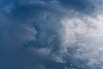 Dramatic view of dark storm clouds forming in the sky, indicating an impending storm with contrasting shades of blue and gray. 