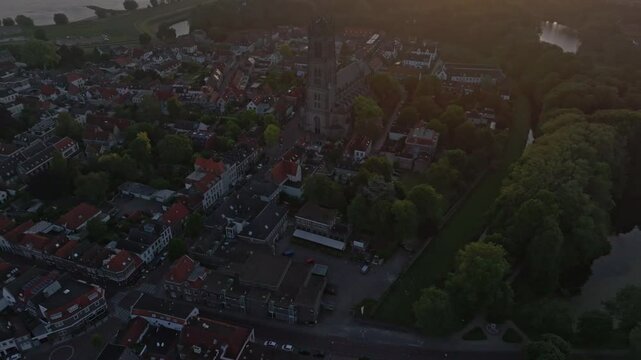 Aerial view of historic town with Sint-Maartenskerk, bridge, vessel, and river Waal, Zaltbommel, Netherlands.