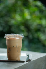 Close up glass of  ice cappucino  on raw cement table of a coffee shop summer terrace, menu photography.