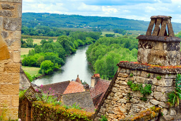 View of the River Dordogne flowing through the landscape as seen from the top of Beynac et Cazenac...