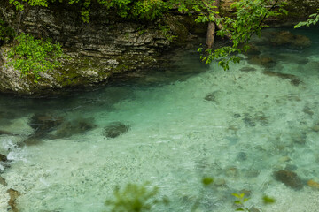 Vintgar Gorges Park a few km from Lake Bled, Slovenia. Wooden walkways accompany the path above the river rapids and waterfalls. River hits rocks and creates fog.Adventure family holidays. Freshness.