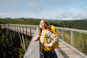 Positive woman tourist enjoying breathtaking view and nature landscapes. Adventure and travel exploring