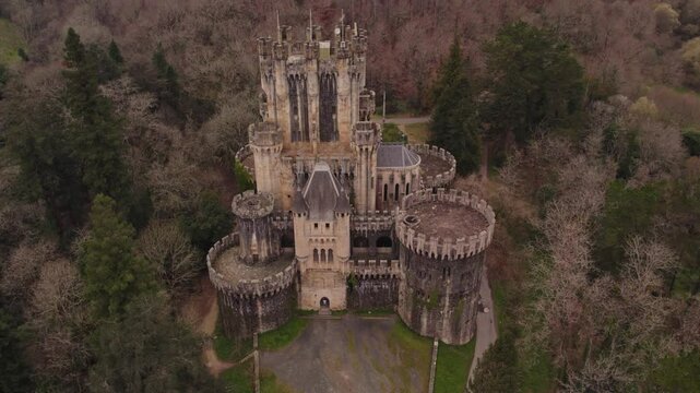Aerial view of medieval castle surrounded by forest in Gatika, Biscay, Spain.