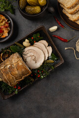 Whole cooked bacon roulade. Tied with a string.