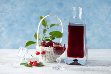 Cherry liqueur in a carafe and glasses