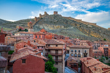 Panoramic view of Albarracín, Teruel, Aragon, Spain, illuminated at dusk, with the medieval old town and walls on the hill in the background © AntonioLopez