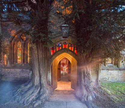 Ghostly figure walking through the archway of an old church at twilight with illuminated stained glass windows. St Edwards Yew