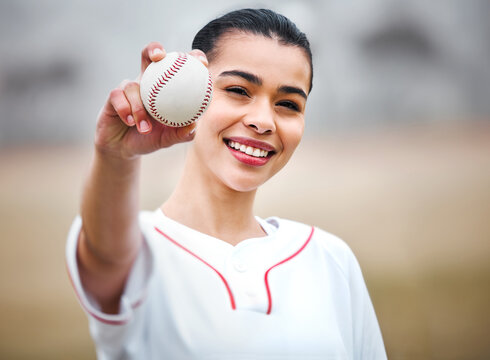 Happy woman, portrait and baseball player with ball for throw, play or game time on outdoor pitch or field. Female person, sports athlete or baller with smile for match, fitness or practice in nature