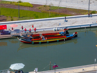 Beautiful aerial view of Aveiro city in Portugal. Aveiro Water canal of Ria de Aveiro with typical boats and tourists, cityscape in the background.