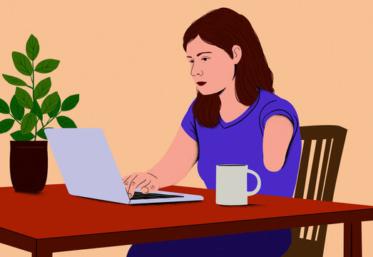 Woman with disability in a purple shirt working on a laptop at a wooden table with a coffee mug and potted plant beside her.