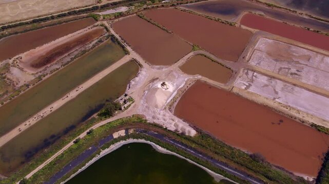 Aerial view of colorful salt pans and geometric fields, Olhao, Portugal.