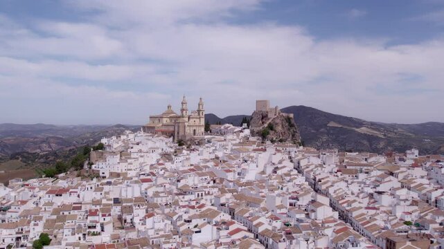 Aerial view of white town with church, castle, and mountain, Olvera, Cadiz, Spain.