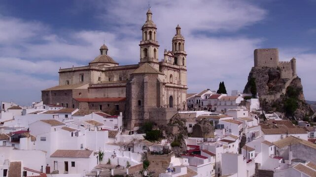 Aerial view of picturesque town with church, castle, and mountains, Olvera, Cadiz, Spain.
