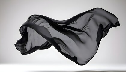 Naklejka premium Wispy, ebony fabric drifting languidly through a clean, bright backdrop, frozen in a state of ethereal suspension
